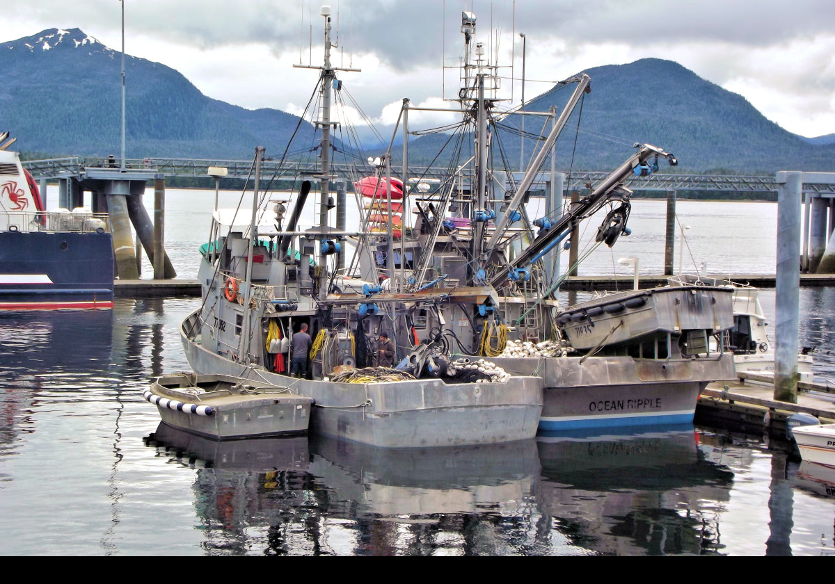 A pair of fishing boats in the harbor near cruise ship berth number 4.