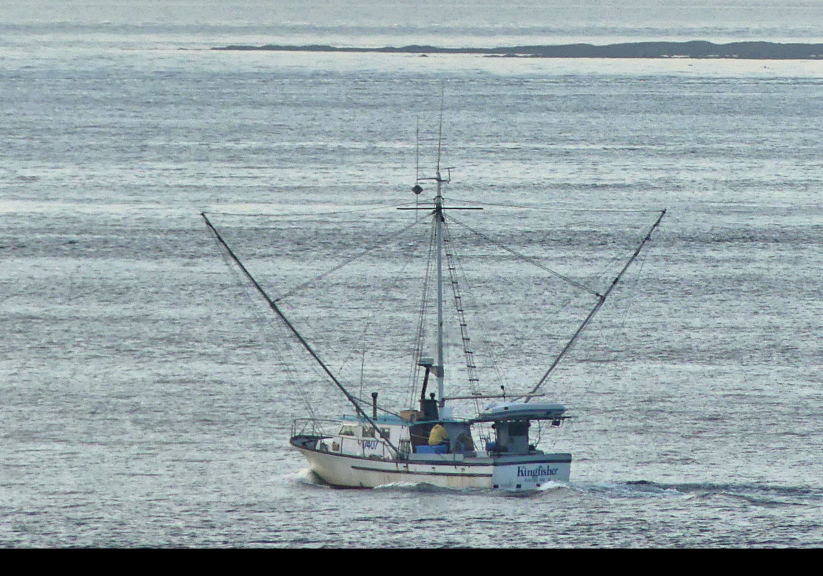 A fishing boat heading out to sea.  