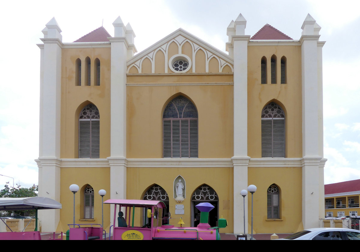 Queen of the Most Holy Rosary Cathedral in Willemstad, also known as Pietermaai Cathedral.  Built in 1870 with an ochre exterior and white trim, it is dedicated to the Virgin Mary and to Dr. José Gregorio Hernández.  Click on the image for an interior view.