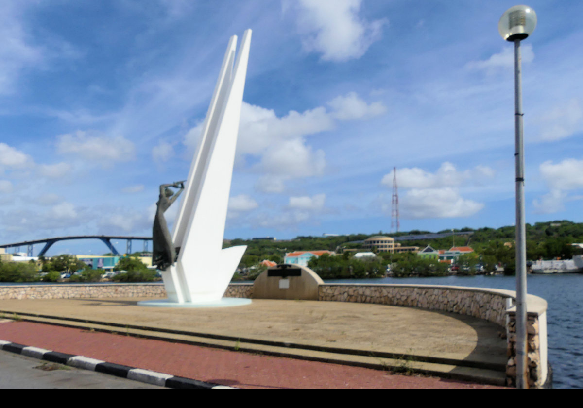 The "Monument to the Fallen".  Situated on De Ruyterkade on the Waaigat waterfront, it commemorates 129 local prople killed in the 2nd World War.  Sculpted in bronze by Federico Carasso in 1957, the sculpture is 11 meters (36 feet) tall.  Memorials on Aruba & Bonaire include the same 129 names.
