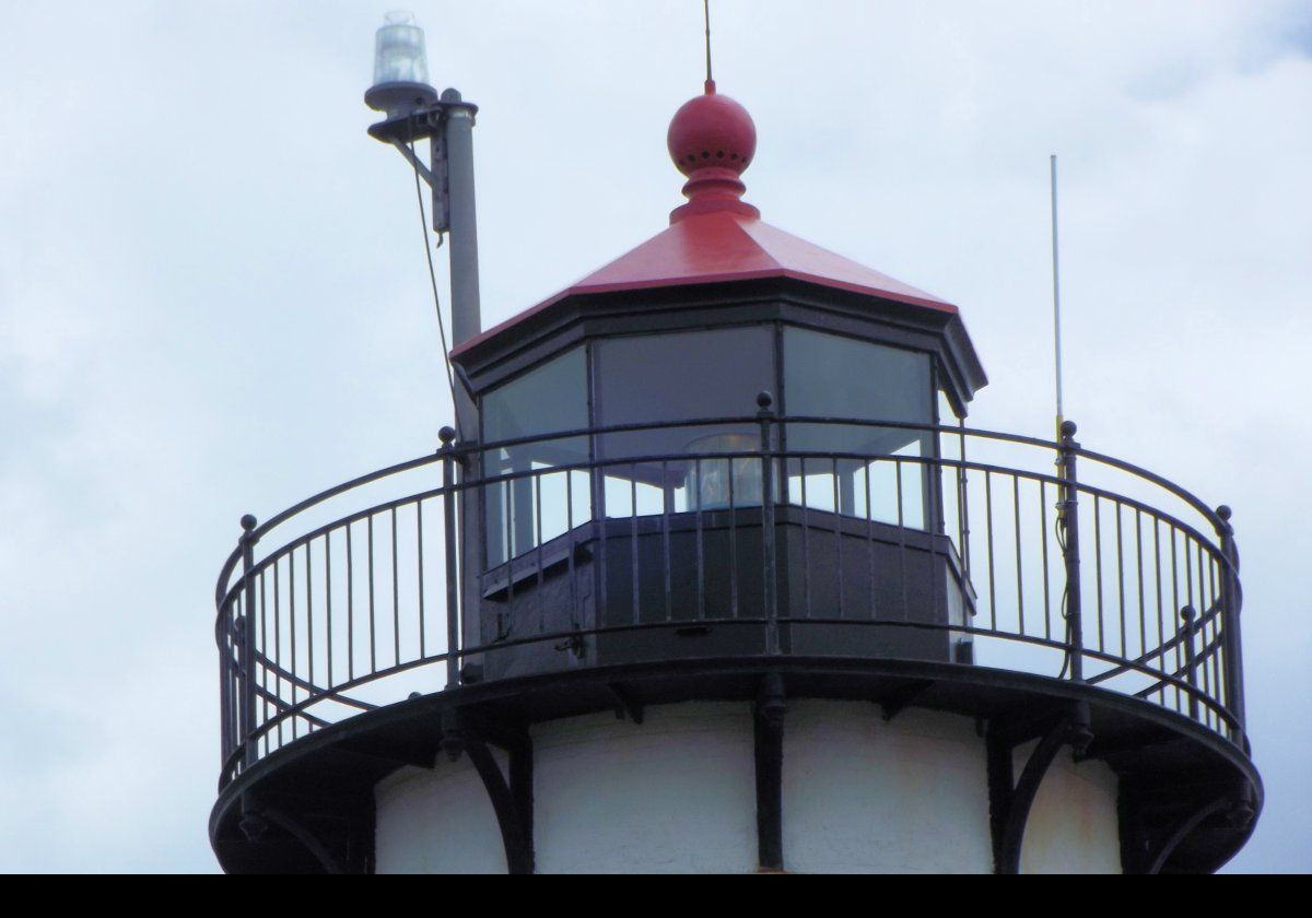 The current lighthouse tower was built In 1890 on the existing foundation of the 1848 tower that had been demolished.  A covered walkway linked the tower to the Keeper's cottage.   1890 also saw construction of a new bell tower.  This picture shows the modern optic now fitted to the lighthouse.  