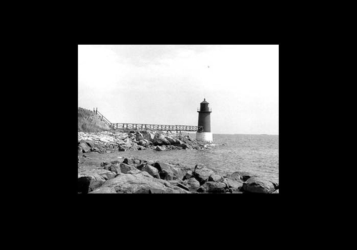 An old Coast Guard picture of the lighthouse with the wooden bridge in place.  The bridge was destroyed and rebuilt twicw in 1879 & 1904.