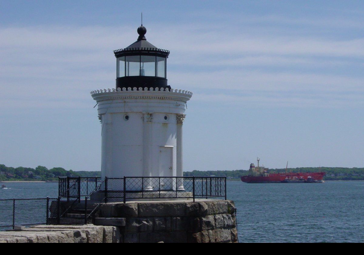 The Portland Breakwater Light.  By 1889, a small keepers house was built adjacent to the lighthouse, and in 1903 a second story was added.  In 1934 the light was electrified, and the following year the keepers cottage was demolished.  During the 1940s, the local shipyards expanded their operations into the harbor reducing the length of the breakwater until, as now, it was only about 100 feet off shore.  It was decommissioned in 1943.  