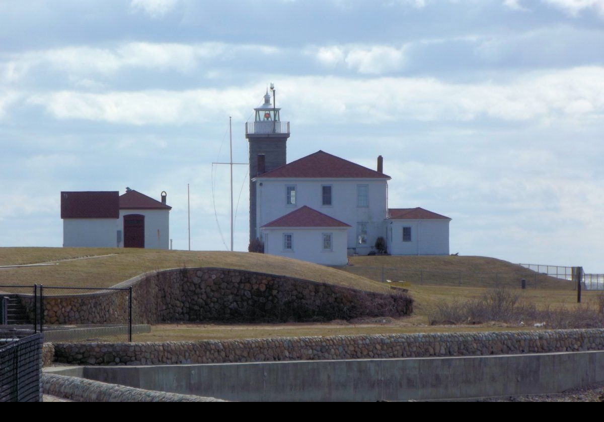 The lighthouse stands about 14 meters (45 feet) tall.  The original optic comprised a fixed white light using a 4th order Fresnel lens.  In about 1916, the light was replaced by a revolving optic;  white light for 10 seconds, then 5 seconds of darkness with 2 flashes of red.  A separate fog signal building was added in 1909.  