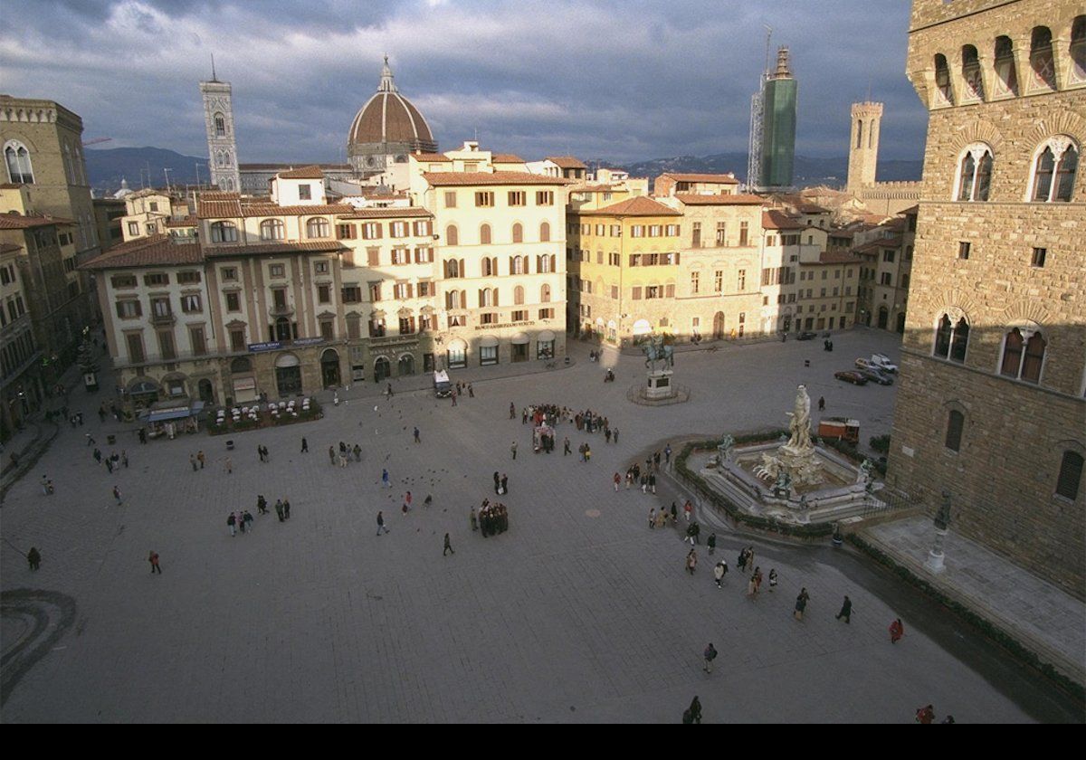 Looking down onto the Piazza della Signoria.  The 14th-century Palazzo Vecchio is on the extreme right, with the Fountain of Neptune at the corner.  Also, on horseback, a statue of Cosimo I de' Medici who was the Duke of Florence then Grand Duke of Tuscany.