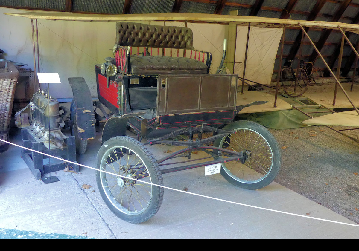 1903 Grout  Steam Car.  Starting in1899, the three Grout brothers, Carl, Fred and C.B. were set up in business by their father, a sewing machine maker, to manufacture steam powered cars.  Not present on this example from 1903 is the drop down front seat for two more passengers.  