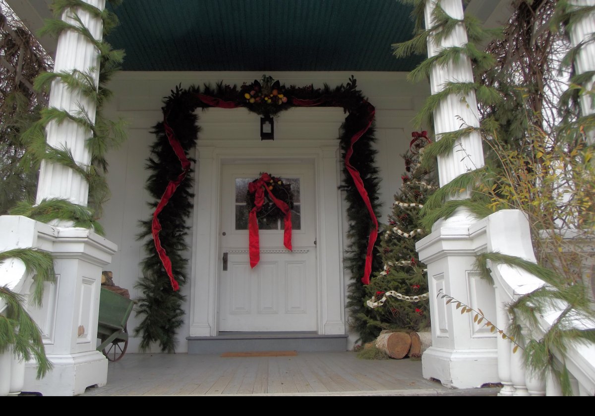 A closeup of the front entrance to the house decorated for the Christmas holiday.
