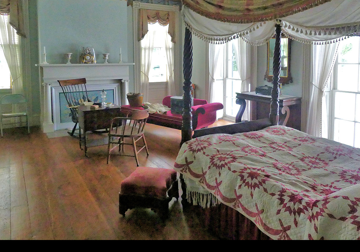 One of the bedrooms with a four poster bed and a chaise longue.    Another interesting clock on the mantle.  Click the image for a closer lok at the clock.