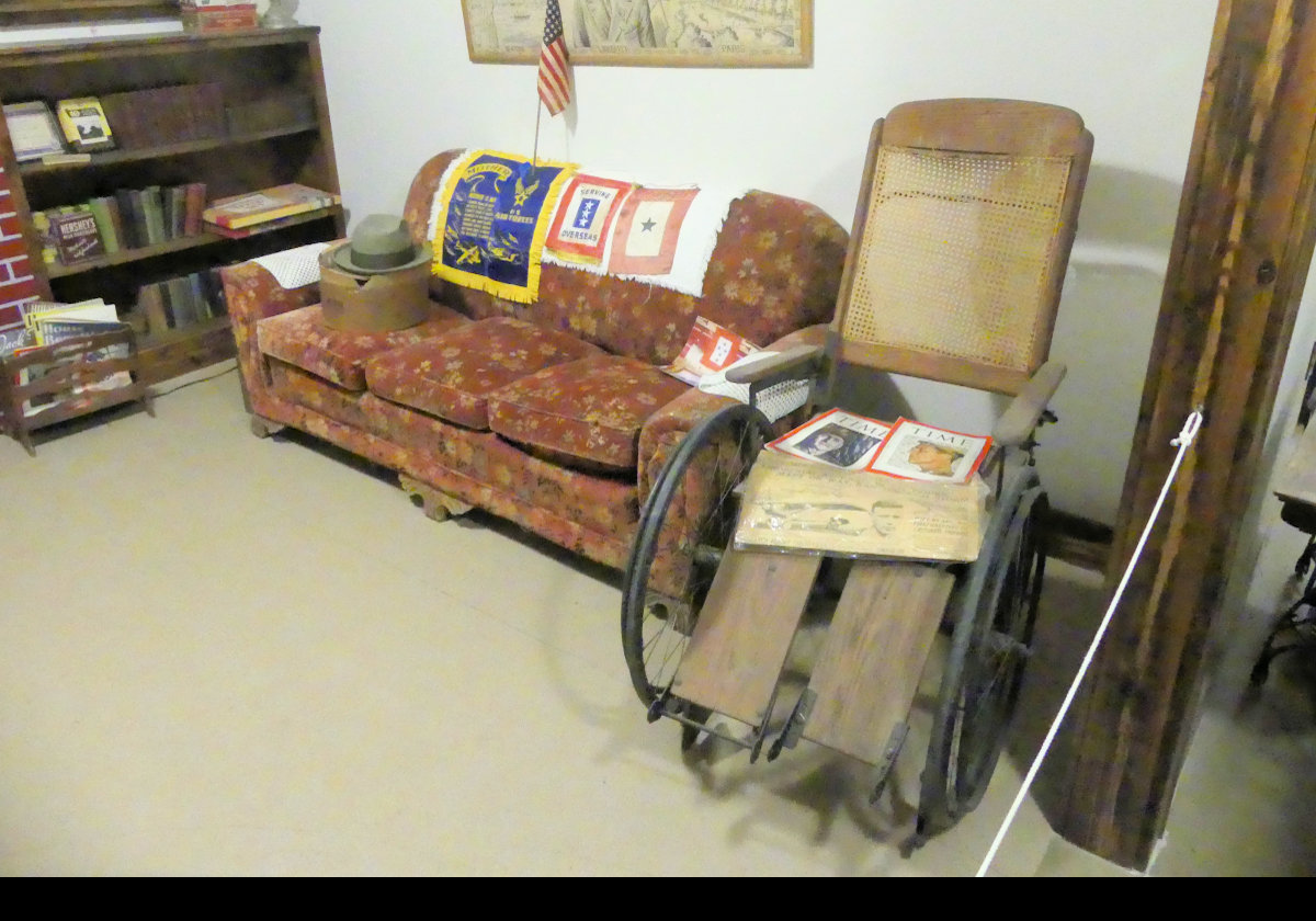 A typical living room from the 1940s with a rather interesting wheelchair. 