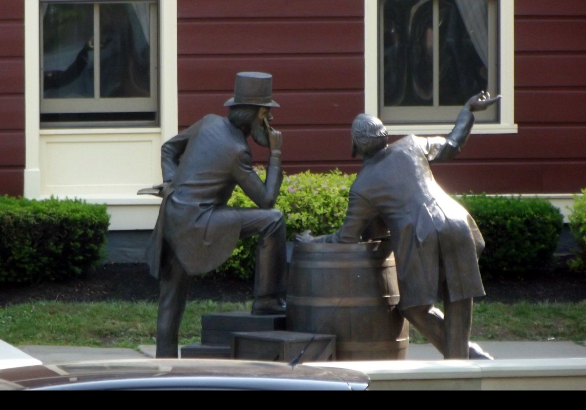 The statue depicts two politicians both named John Hamilton Gray; one the former premier of Prince Edward Island, and the other a politician from New Brunswick.  The original plaque misspelt their names as Grey!