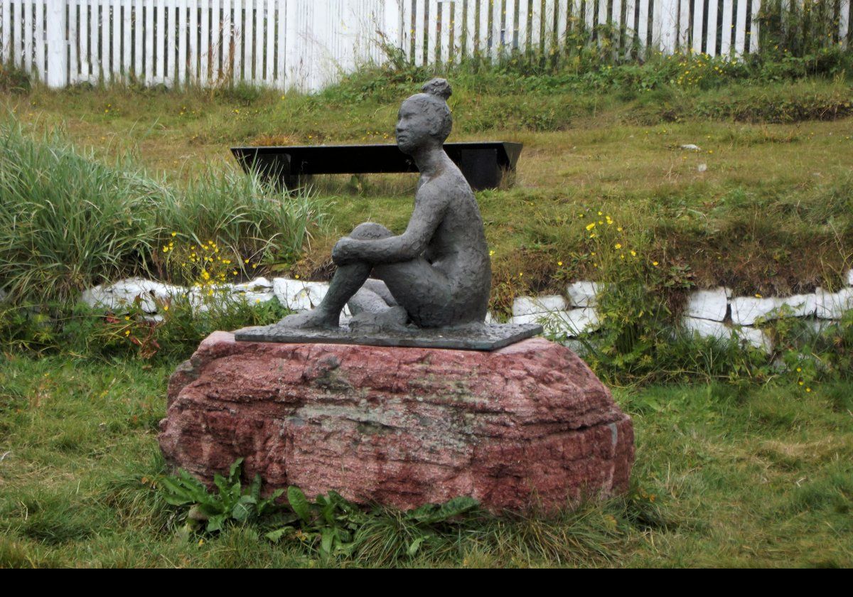 The Qaqortoq Maid statue situated near the fountain.