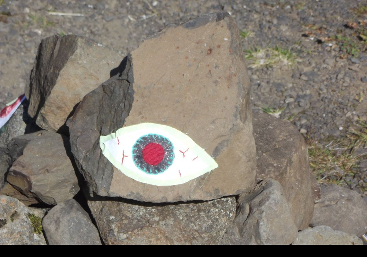 A colorful sculpture on the side of the road.  Closeup on a single eye!