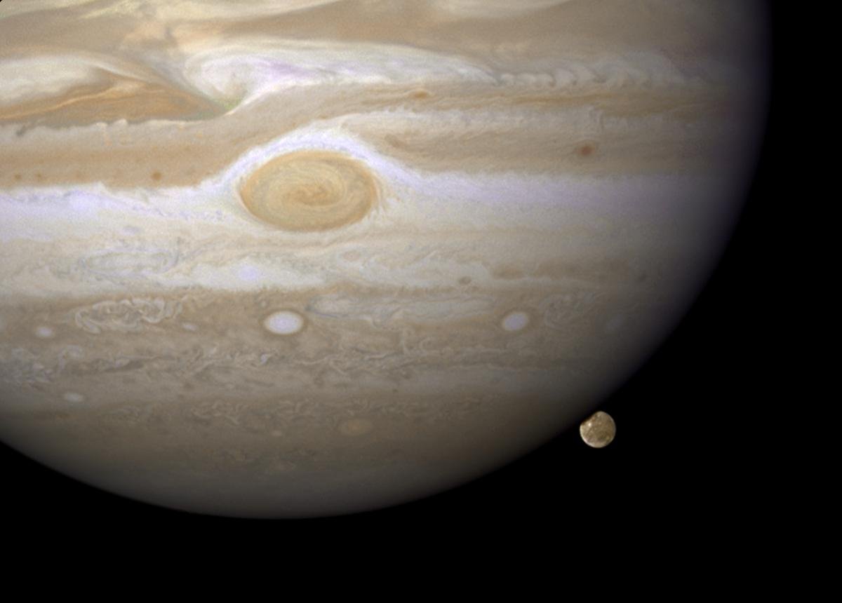 Hubble Space Telescope image of Jupiter's moon Ganymede just before it passes behind Jupiter's disk.  You can see Jupiter's Great Red Spot, which is a storm about twice the size of Earth.  The spot has been around for at least 300 years.