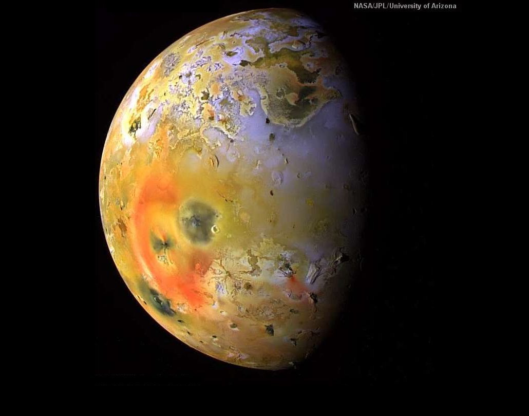The Galileo probe took this photograph on September 19, 1997 from a distance of more than 500,000 kilometers (310,000 miles).  The image has been color enhanced, and shows sulfur dioxide frost in white and grey with sulfur in yellows and browns.  The red areas and the dark spots indicate recent volcanic eruptions.  The almost circular red ring surrounds Pele, and the dark spot breaking the red ring is the volcano Pillan Patera.  This produced a 120 kilometer (75 mile) high plume in an earlier eruption.  