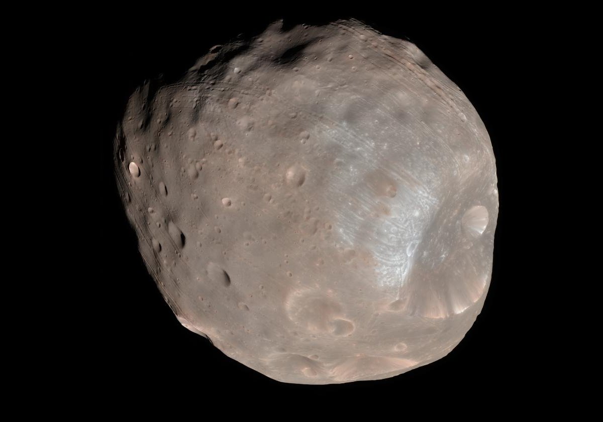 Of Mars' two moons, Phobos is the larger at about 27 x 22 x 18 km.  It also orbits closer to Mars than Deimos at a distance of only 9,377 km (5,827 miles) from the center of Mars.  Due to being so close, and suffering the affect of the tides induced by Mars, its orbit is decaying so it will eventually hit Mars or, as is more likely, get broken up.  This is likely to occur in about 7 to 11 million years time.  