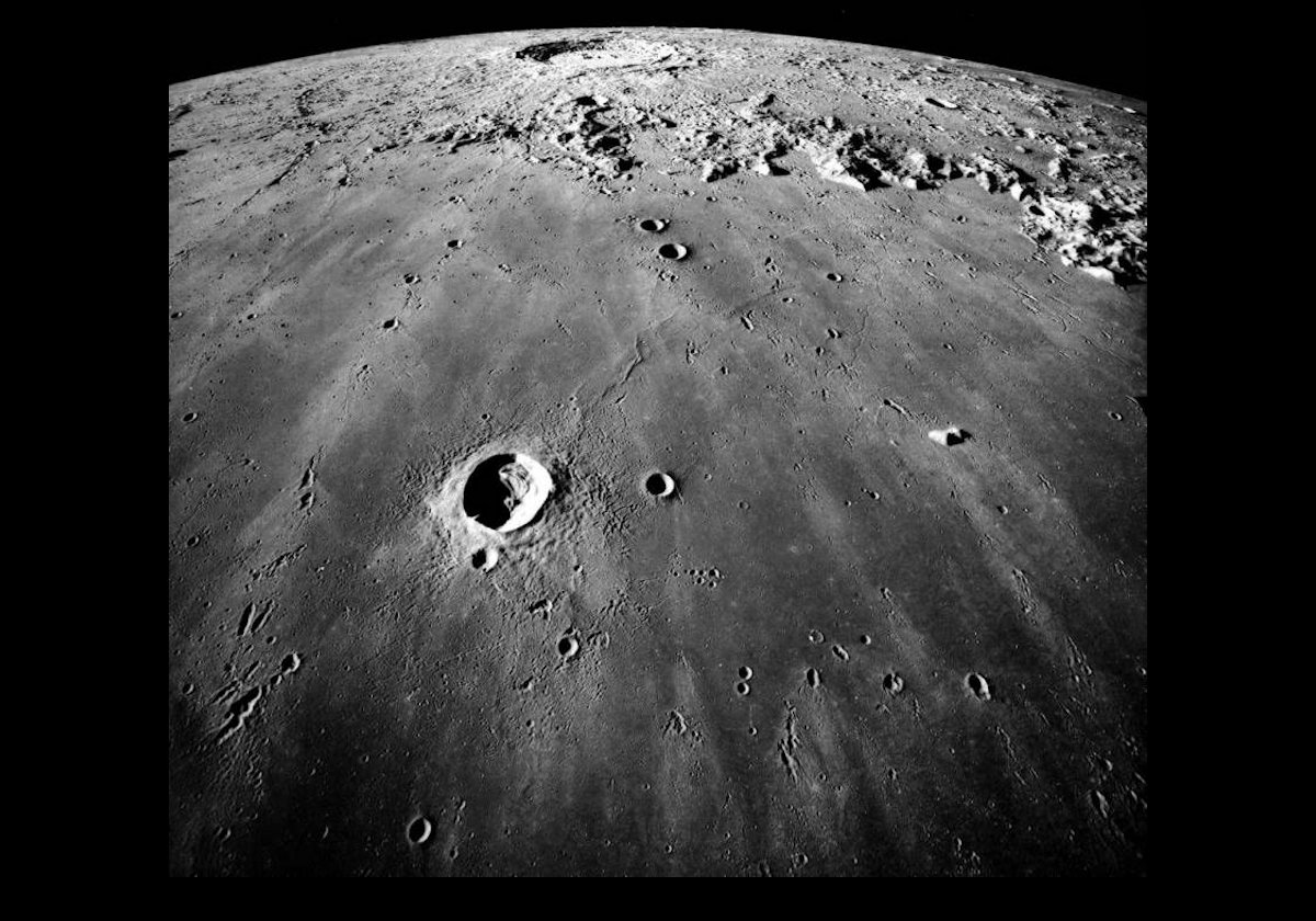Mare Imbrium is in the foreground, while the Copernicus Crater (click image for another view) is at center near the horizon.  The large crater near the center is Pytheas.  You can see the Montes Carpatus mountains at  the upper edge of the Mare Imbrium. The distance from the lower edge of the image to the center of Copernicus is about 250 miles (400 km).  Credit: NASA.  Taken by Apollo 17