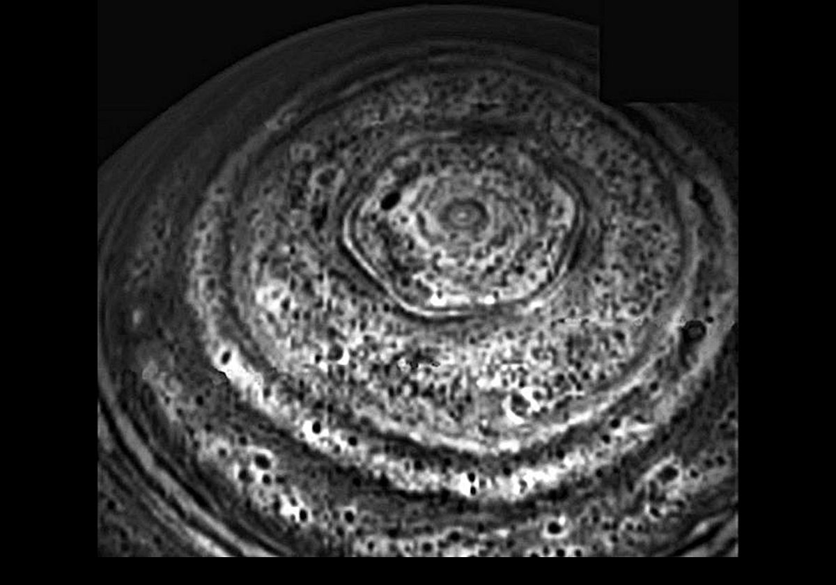 A Cassini image of the six-sided feature that encircles Saturn's north pole.  The nested set of alternating white & dark hexagons indicates that the feature extends at least 75 km (47 miles) underneath the clouds.  The outer, straight sides are approximately 13,800 km (8,625 miles) long.  The feature is nearly stationary, & is probably an unusually strong pole-encircling planetary wave.  
