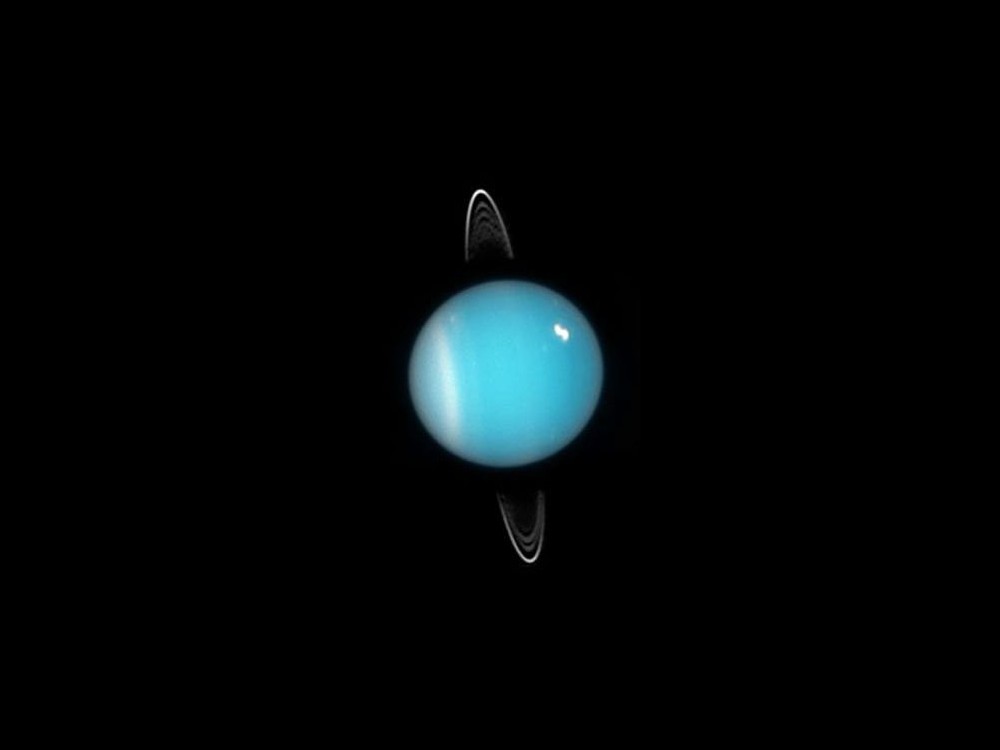 2005 Image of Uranus from the Hubble Space Telescope. Rings, southern collar and a bright cloud in the north are visible.  Credit NASA, ESA, & M. Showalter