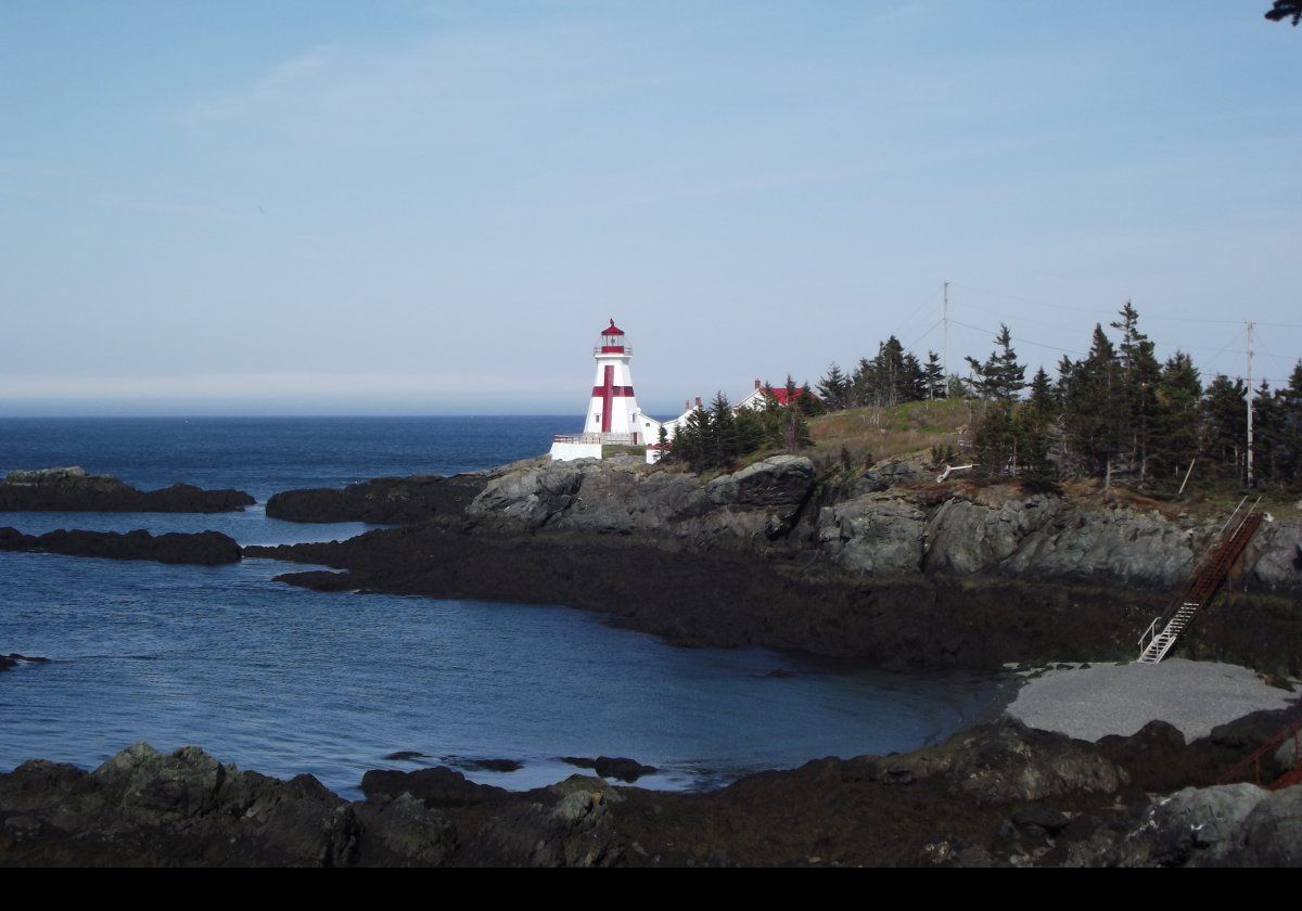 Built in 1829, Head Harbour (or East Quoddy to Americans) Lighthouse sits on a small rocky outcropping just off the northern tip of Campobello Island in Canada.  The tower is 51 feet (just over 15.5 meters) tall with a red cross and a red lantern room.  